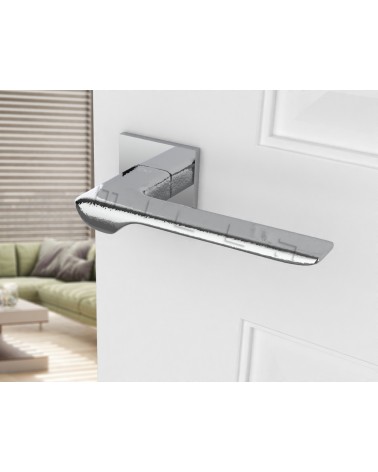 Polished chrome LINE design door handle angled view mounted on a door