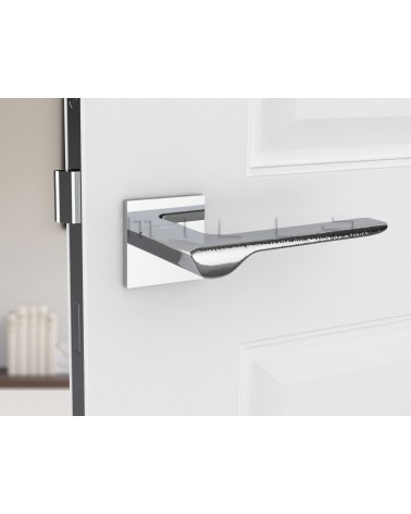 Polished chrome LINE design door handle front view mounted on a door