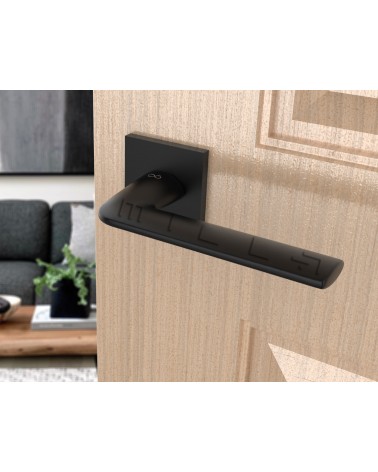 Black STINGER door handle designer handle angled view mounted on a door
