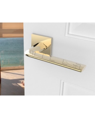 Gold STINGER door handle designer handle angled view mounted on a door