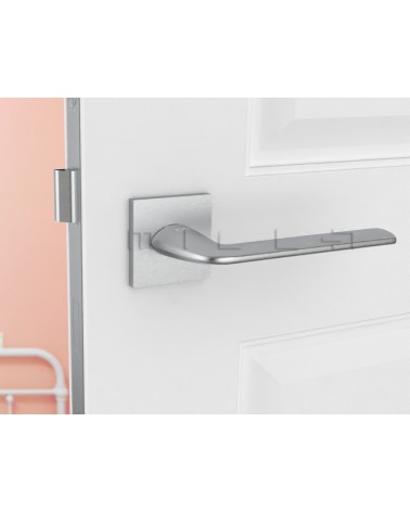 STINGER brushed chrome designer door handle front view mounted on a door