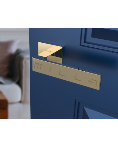 Polished gold Apollo door handle designer handle angled view mounted on a door