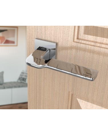 Polished chrome LINE BALI door handle design ironmongery angled view mounted on a door