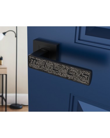 Black GLAMOUR door handle design ironmongery angled view mounted on an ajar door