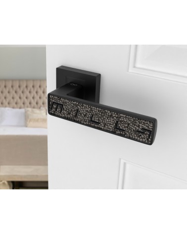 Black GLAMOUR door handle design ironmongery angled view mounted on a door