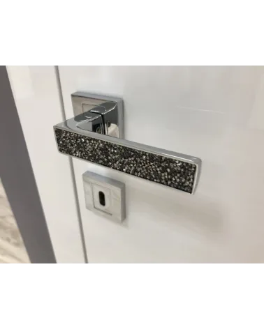 Polished chrome GLAMOUR door handle design ironmongery angled view mounted on a door