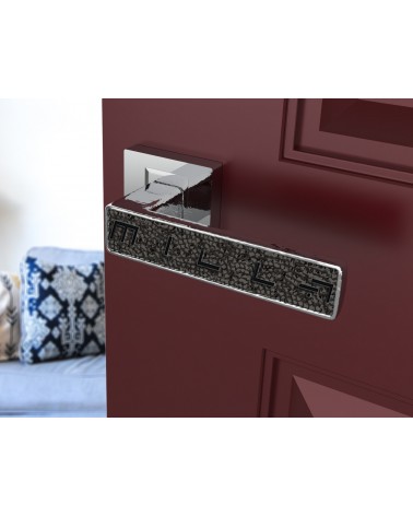 Polished chrome GLAMOUR door handle design ironmongery angled view mounted on an ajar door