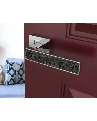 Polished chrome GLAMOUR door handle design ironmongery angled view mounted on an ajar door