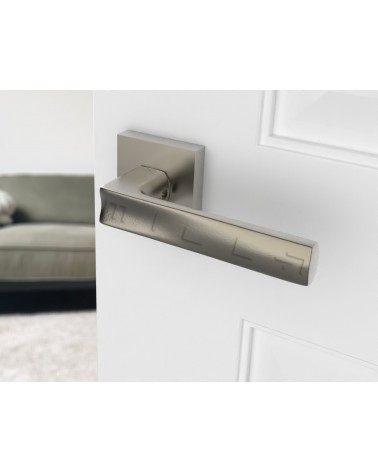 Satin nickel door handle DIUNA designer handle angled view mounted on a door