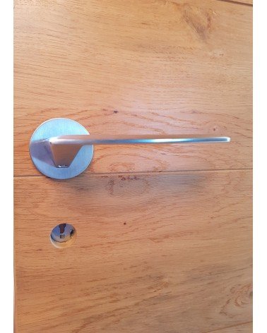 Brushed chrome Line GIULIA door handle design handle front view mounted on a door