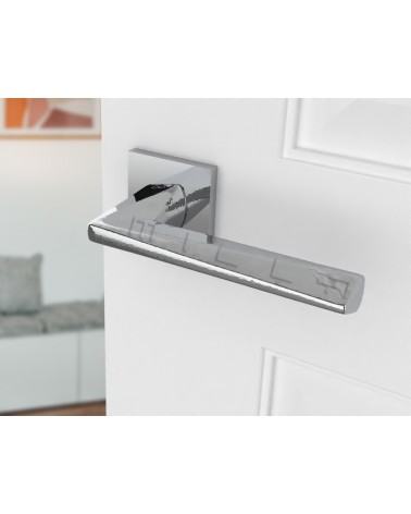 Polished chrome DIAMANT door handle design angled view mounted on a door