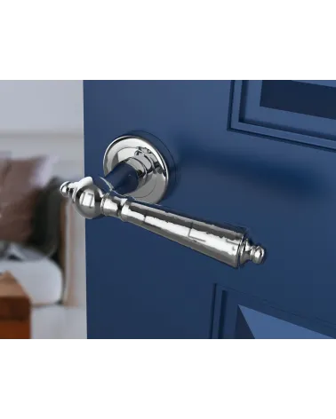 Polished chrome MILLENAIRE door handle design handle angled view mounted on a door