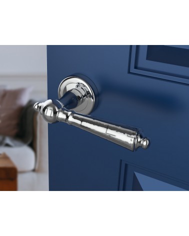 Polished chrome MILLENAIRE door handle design handle angled view mounted on a door
