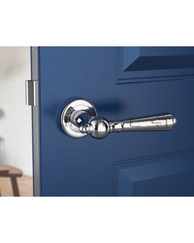 Polished chrome MILLENAIRE door handle designer handle front view mounted on a door