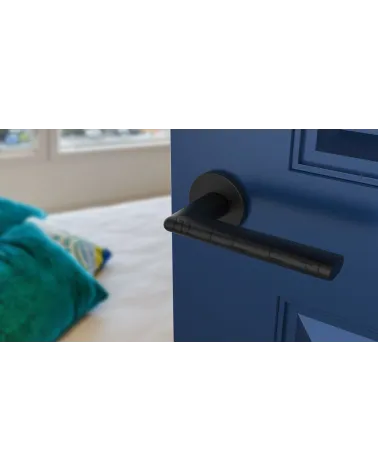 KALMIA zamak door handle design handle top angled view mounted on a door