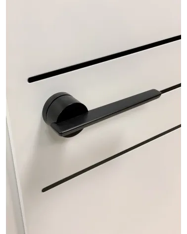 Futuristic JUMELLE door handle design handle tilted top view mounted on a door
