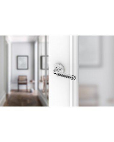 Polished chrome ARIA Slim door handle design handle mounted on a door