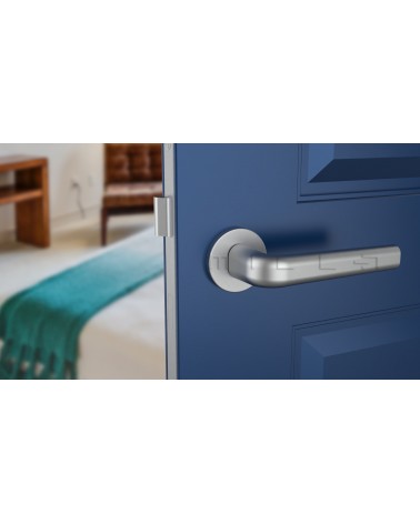 INULLA satin chrome door handle design handle front view mounted on a door
