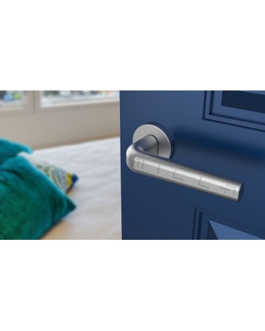 INULLA satin chrome door handle design handle angled view mounted on a door