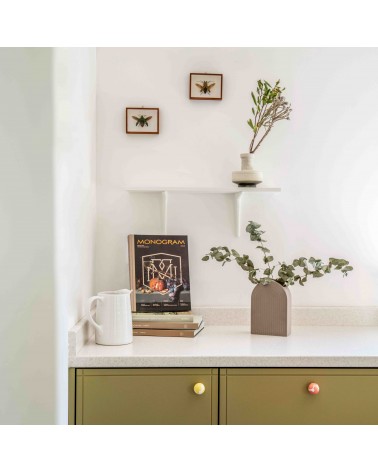 Yellow beech wood furniture knob design handle front view installed on a chest of drawers