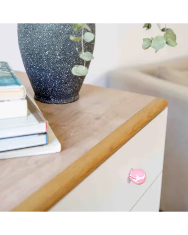 Pink beech wood furniture knob design handle angled top view fixed on a cabinet