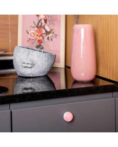 Pink beech wood furniture knob design handle fixed on a cabinet drawer