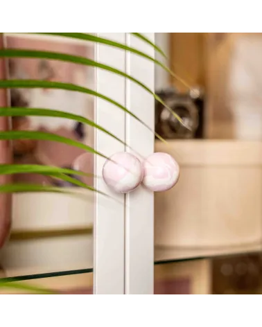 Lilac beech wood furniture knob design handle angled view fixed on a glass door with a blurred background
