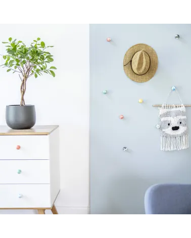 Orange beech wood furniture knob design handle installed on a white chest of drawers topped with a potted plant