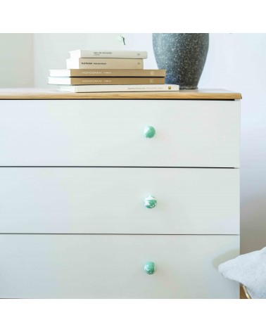 Rich green beech wood furniture knob design handle installed on a white chest of drawers