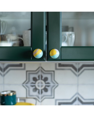 Funky yellow beech wood furniture knob design handle front view fixed on a kitchen cabinet