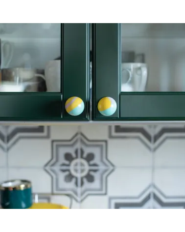 Funky yellow beech wood furniture knob design handle front view fixed on a kitchen cabinet