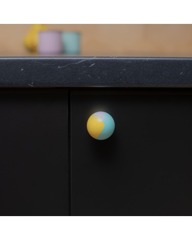 Funky yellow beech wood furniture knob design handle fixed on a cabinet front