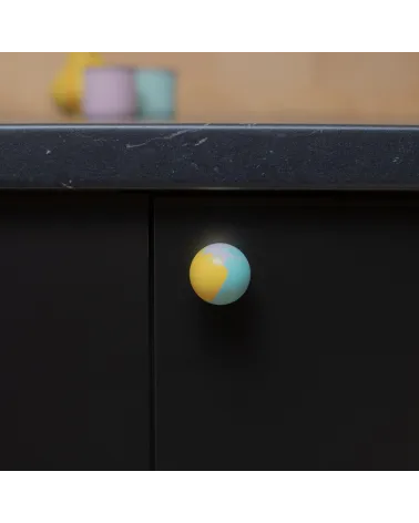 Funky yellow beech wood furniture knob design handle fixed on a cabinet front