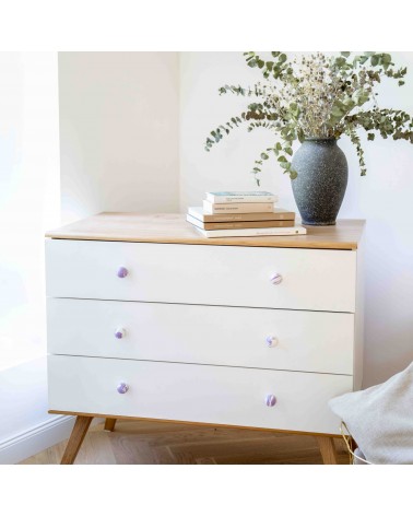 Aubergine beech wood furniture knob design handle installed on a white chest of drawers topped with a potted plant