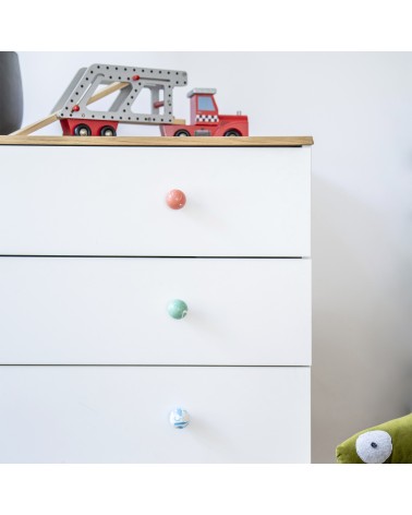 Cherry red beech wood furniture knob design handle installed on a white chest of drawers