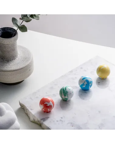 Cherry red beech wood furniture knob design handle placed on a white marble surface