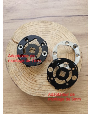 Two quick-fit mounting adaptors for door handles front view, placed on a wooden table