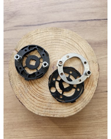 Two quick-fit mounting adaptors for door handles rear view, placed on a wooden table