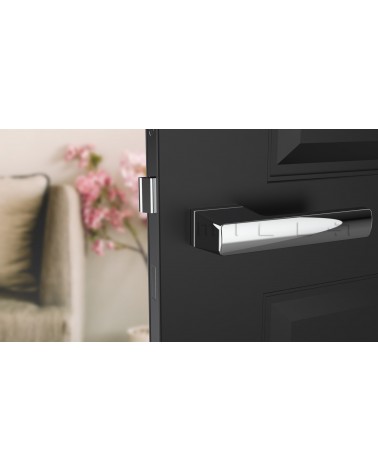 Polished chrome BRISA design door handle fitted on a half-open door
