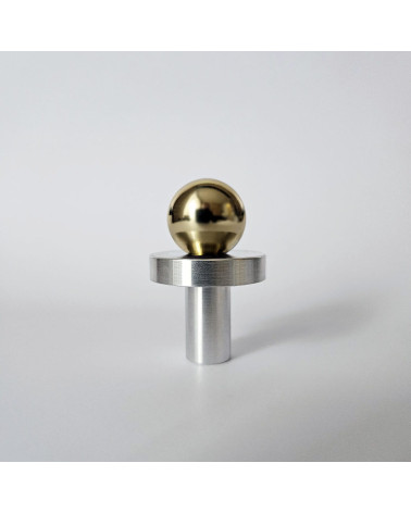 Polished gold/polished chrome furniture knob POLA designer knob on grey background