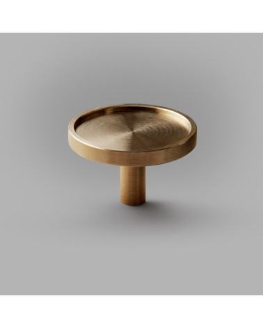 INA brass furniture knob designer handle placed on a grey background