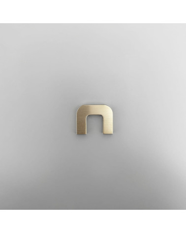 ISA XS polished gold furniture handle designer handle front view on grey surface