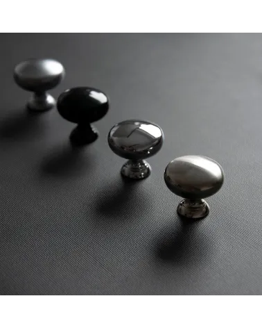 TORONTO furniture knob designer handle arranged diagonally on a dark surface