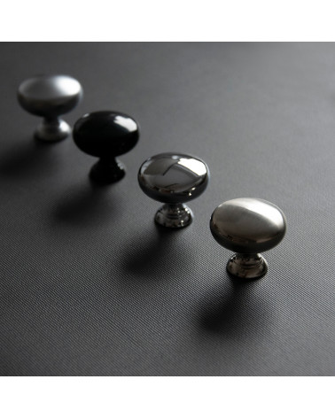 TORONTO furniture knob designer handle arranged diagonally on a dark surface