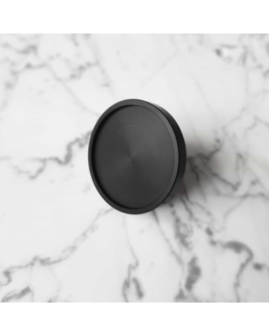 INA BLACK black furniture knob design handle large model placed on a marbled surface