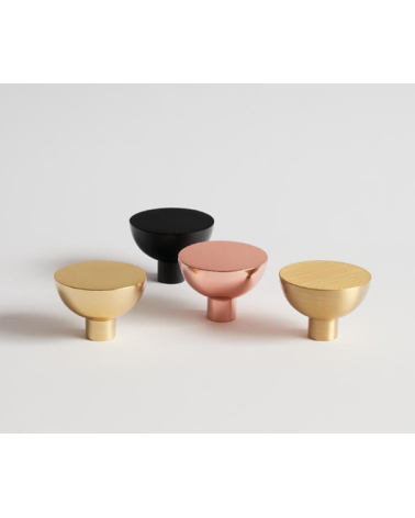 LUNA M furniture knob design handle placed on a light surface