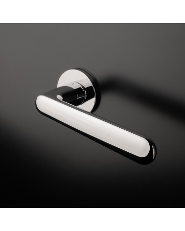 Polished chrome ARIA design handle mounted on a door