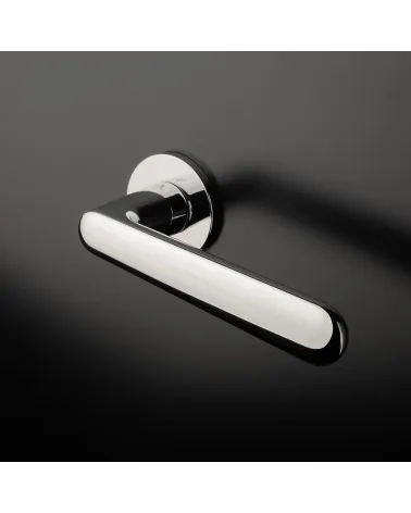 Polished chrome ARIA design handle mounted on a door