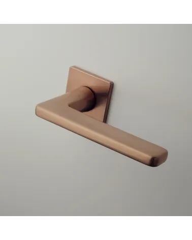 Copper door handle SETIA designer handle mounted on a door
