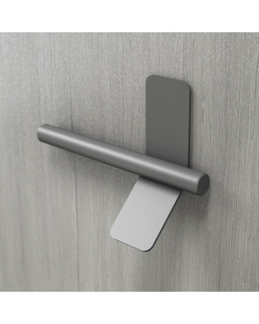 Anthracite furniture handle TORN-4 design handle mounted on a grey surface